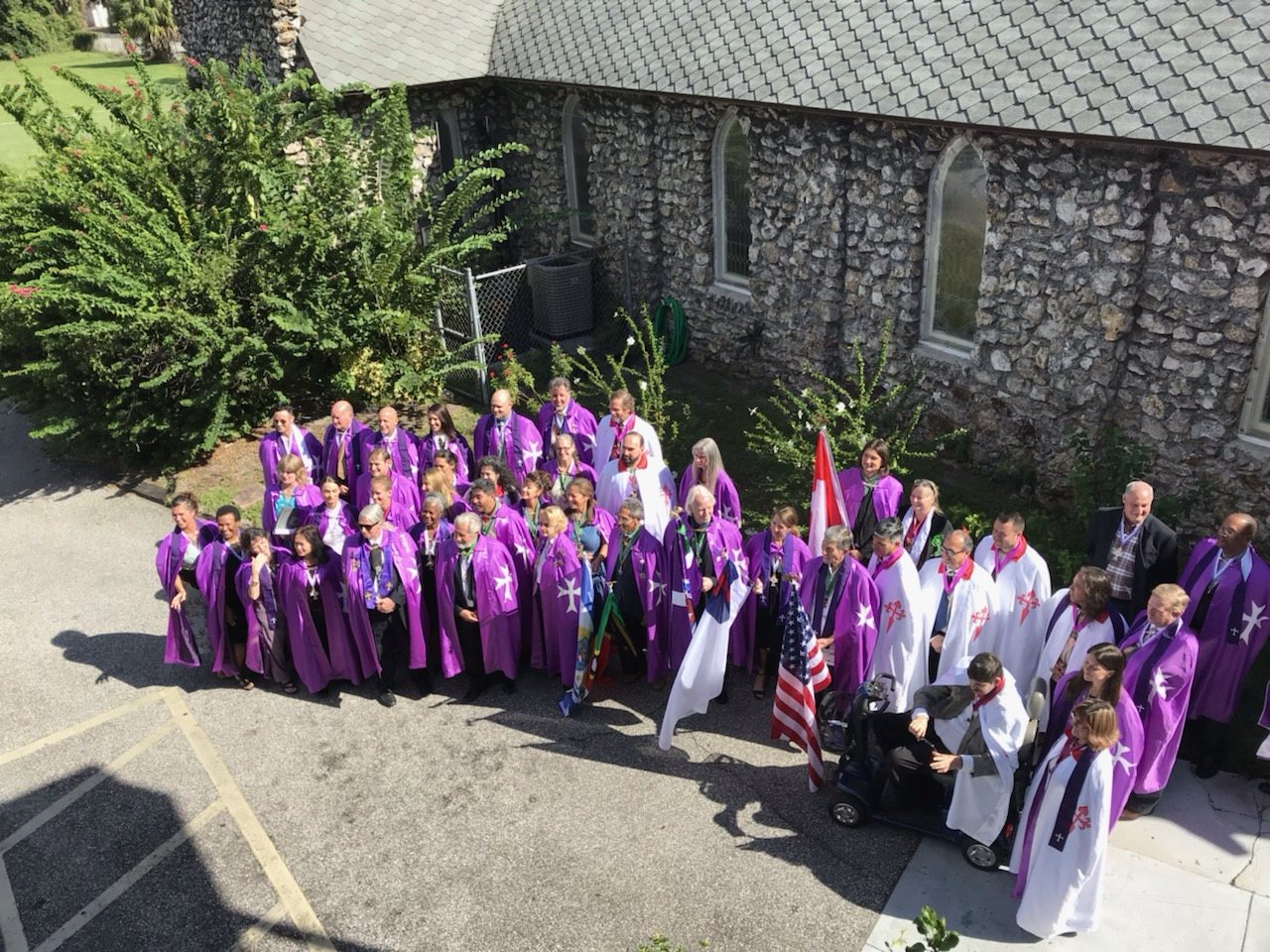 Members of the Order gathered at a stone chapel